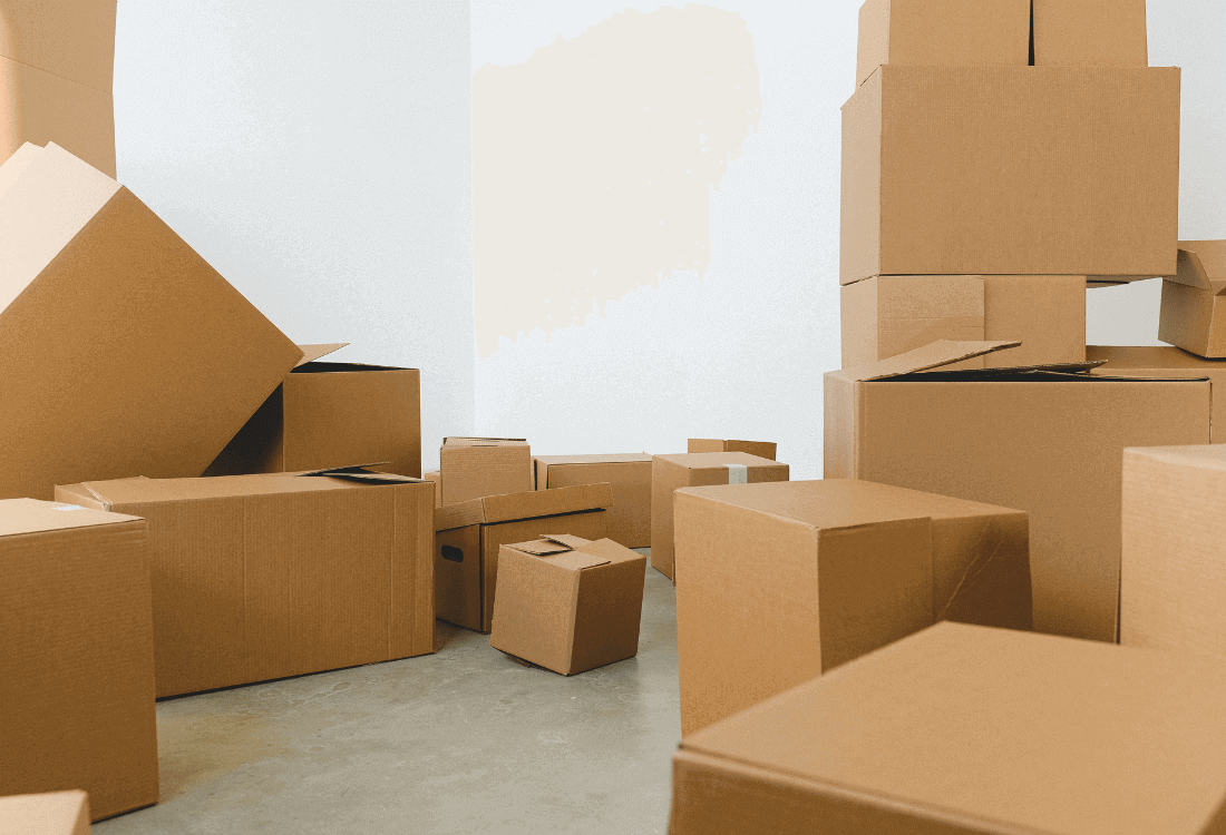 Lots of boxes stacked in the corner of the room symbolising corporate relocation