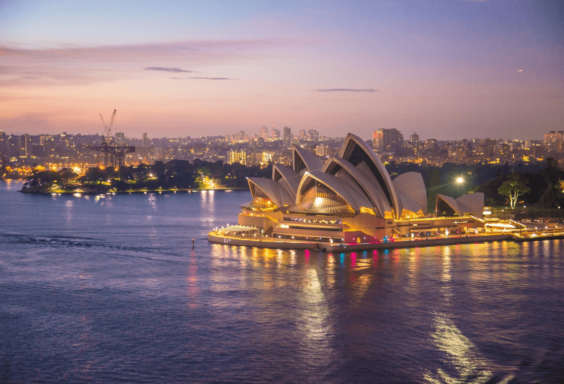 An employer in Sydney overlooking the night skyline before moving